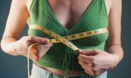 Woman measuring her bust with a tape measure