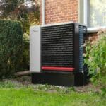 Outdoor heat pump unit next to a brick building