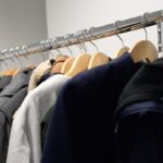 Vêtements accrochés sur un porte-manteau métallique dans une pièce