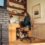 Woman working at a desk in a cozy home office