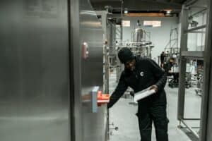 A man inspects equipment in a modern factory