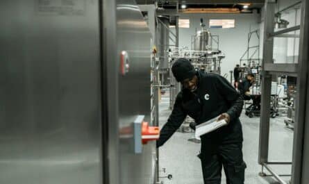 A man inspects equipment in a modern factory