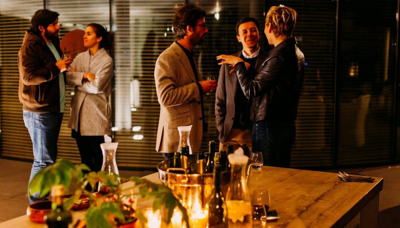 five person standing while talking each other