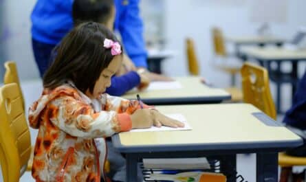 toddler sitting on desk